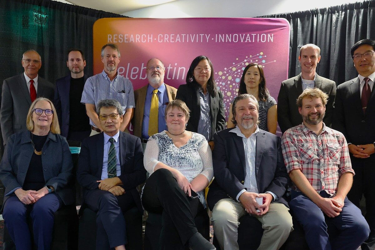 a group of people posing for a photo after winning awards